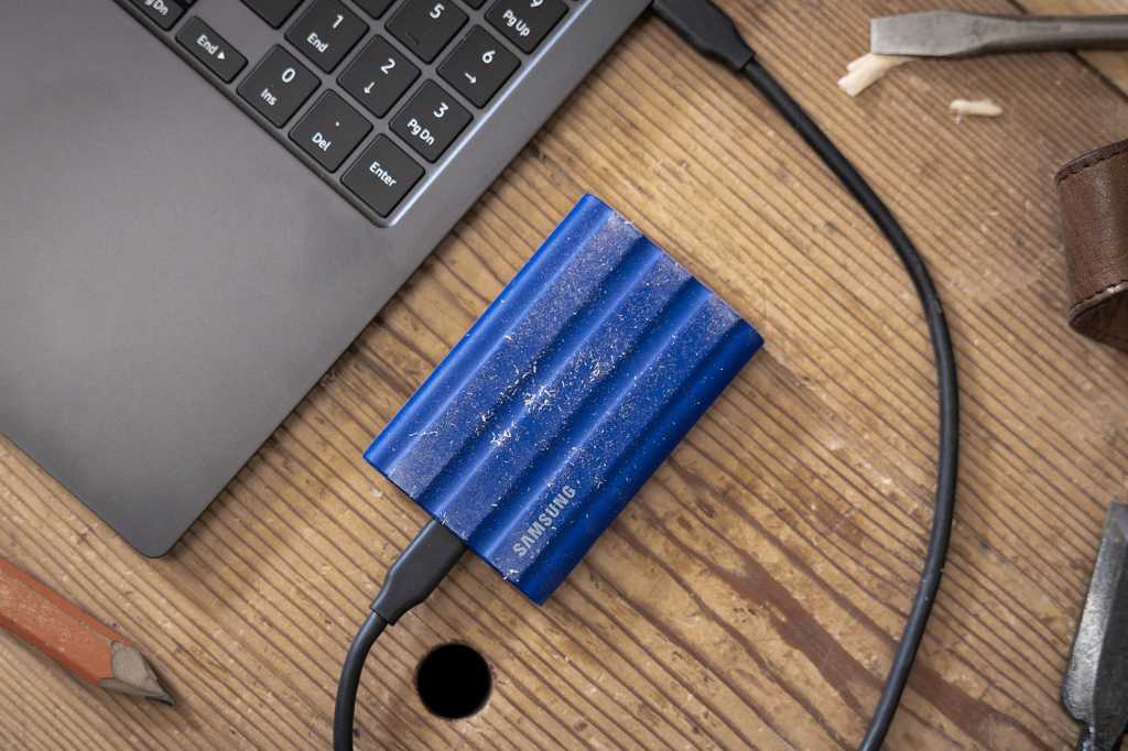 Samsung T7 Shield portable SSD lifestyle shot on wooden table